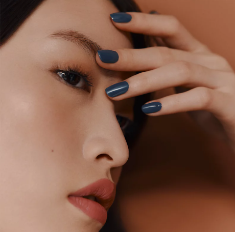 Close-up portrait with dark nails and defined eyelashes